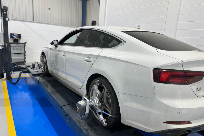 Wheel Alignment Machines fitted on a car in a bay